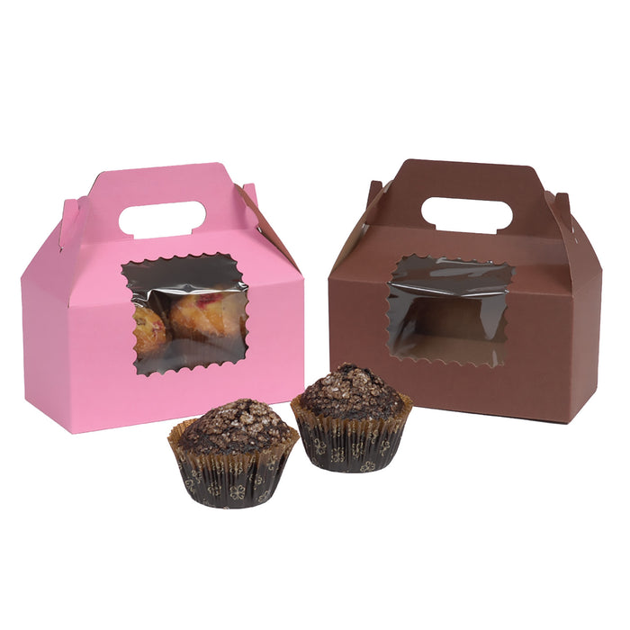Two gable-style bakery carry boxes for cupcakes, one pink and one brown, with a clear window showing pastries inside, with two cupcakes in front on a white background.