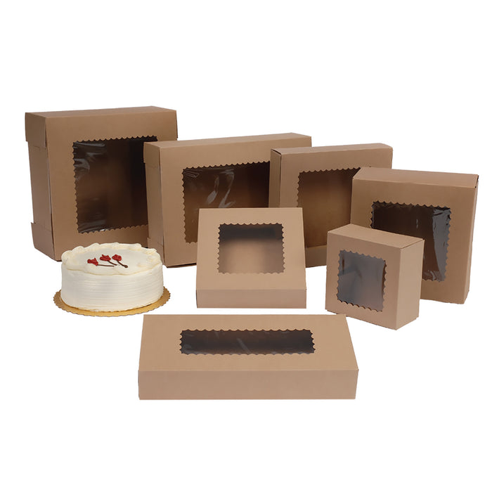 Brown Kraft bakery boxes with clear plastic window cutouts in various sizes, shown on a white background with a small white frosted cake beside one box.
